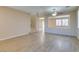 Living room with wood-look tile floors, staircase, and access to backyard at 26 Drawback St, Henderson, NV 89012