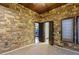 Stone-accent bedroom with double doors to closet and carpet flooring at 33 Promontory Ridge Dr, Las Vegas, NV 89135