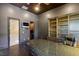 Home office with built-in bookcases, desk, and adjacent bathroom at 33 Promontory Ridge Dr, Las Vegas, NV 89135