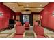 Home theater with red velvet seating and projector at 33 Promontory Ridge Dr, Las Vegas, NV 89135