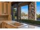 Kitchen with farmhouse sink and view of the backyard pool at 33 Promontory Ridge Dr, Las Vegas, NV 89135
