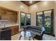Home office with wet bar, glass-top table, and French doors at 33 Promontory Ridge Dr, Las Vegas, NV 89135