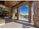 Covered patio with stone pillars overlooks the pool area at 33 Promontory Ridge Dr, Las Vegas, NV 89135