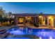 Luxury pool and home at night with lights at 33 Promontory Ridge Dr, Las Vegas, NV 89135