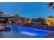 Inviting pool with illuminated waterfall at night at 33 Promontory Ridge Dr, Las Vegas, NV 89135