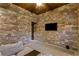 Recreation room featuring a stone accent wall and media setup at 33 Promontory Ridge Dr, Las Vegas, NV 89135