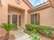 Front entry with landscaping and a dark brown door at 4 Kennesaw Rd, Henderson, NV 89052