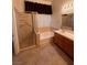 Well-lit bathroom featuring a shower, separate soaking tub, and single sink vanity at 5025 Vista Loma Way, North Las Vegas, NV 89031