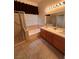 Bathroom with double sink vanity, shower stall, bathtub, and window at 5025 Vista Loma Way, North Las Vegas, NV 89031