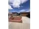 Inviting single-story home with a two-car garage, desert landscaping and a brick border at 5025 Vista Loma Way, North Las Vegas, NV 89031