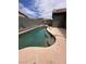 Backyard showcases a pool with a tanning ledge and a waterfall feature at 5025 Vista Loma Way, North Las Vegas, NV 89031