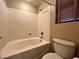 Bathroom featuring a tub with shower and tile walls at 7961 Alta Lima Valley Ct, Las Vegas, NV 89178