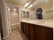 Bathroom featuring a double sink vanity with tile floors, shower and bathtub at 7961 Alta Lima Valley Ct, Las Vegas, NV 89178