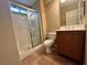 A bathroom features a shower stall, toilet, and vanity with wood cabinet at 7961 Alta Lima Valley Ct, Las Vegas, NV 89178