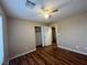 This bedroom features wood-look floors, a ceiling fan, and a closet for storage at 7961 Alta Lima Valley Ct, Las Vegas, NV 89178