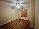 This bedroom features wood-look floors, a ceiling fan, and a window for natural light at 7961 Alta Lima Valley Ct, Las Vegas, NV 89178