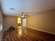 Large bedroom features a ceiling fan, wood flooring, and ensuite bathroom at 7961 Alta Lima Valley Ct, Las Vegas, NV 89178