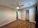 This bedroom features wood-look floors, a ceiling fan, closet, and attached shelving closet at 7961 Alta Lima Valley Ct, Las Vegas, NV 89178