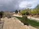 Neighborhood path with landscaping, lighting, and natural beauty offering a scenic route for residents and visitors at 7961 Alta Lima Valley Ct, Las Vegas, NV 89178