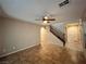 Spacious entryway featuring tile flooring, a staircase with wood railing, and neutral walls at 7961 Alta Lima Valley Ct, Las Vegas, NV 89178