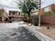 Two-story home with a two-car garage, desert landscaping, and a concrete driveway at 7961 Alta Lima Valley Ct, Las Vegas, NV 89178