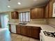 Functional kitchen with wood cabinets, double sink, and access to the backyard at 7961 Alta Lima Valley Ct, Las Vegas, NV 89178