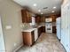 Practical kitchen layout with wood cabinets, white appliances, and durable tile flooring at 7961 Alta Lima Valley Ct, Las Vegas, NV 89178