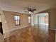 Open-concept living room with tile flooring, a ceiling fan, and natural lighting at 7961 Alta Lima Valley Ct, Las Vegas, NV 89178