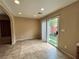 Bright living room featuring tile floors and sliding glass door to the backyard at 7961 Alta Lima Valley Ct, Las Vegas, NV 89178