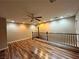 Open loft space with wood flooring, natural light, and a ceiling fan at 7961 Alta Lima Valley Ct, Las Vegas, NV 89178
