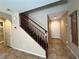 Entryway with a staircase featuring wood railing and tile flooring at 7961 Alta Lima Valley Ct, Las Vegas, NV 89178