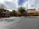 Neighborhood street with well-maintained homes, desert landscaping and mature trees at 7961 Alta Lima Valley Ct, Las Vegas, NV 89178