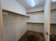Walk-in closet with wood shelving and carpeted floor at 7961 Alta Lima Valley Ct, Las Vegas, NV 89178