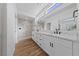 Modern bathroom with dual sinks, white marble countertops, and a walk-in shower at 8517 Bayland Dr, Las Vegas, NV 89134