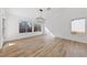 Bright living room with large windows, modern light fixture, and wood-look floors at 8517 Bayland Dr, Las Vegas, NV 89134
