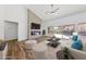 Bright living room with wood floors, fireplace, ceiling fan, and a sliding glass door to the backyard at 8517 Bayland Dr, Las Vegas, NV 89134