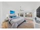 Light-filled primary bedroom featuring a ceiling fan, picture windows, and stylish decor at 8517 Bayland Dr, Las Vegas, NV 89134