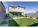 Artificial turf backyard with a covered patio and sitting area at 9888 Abel Cliff St, Las Vegas, NV 89143