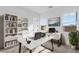 Bright home office with a modern desk, bookshelf, and a large window view at 311 S Lisbon St, Henderson, NV 89015