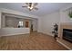 Spacious living room featuring hardwood floors, fireplace, and ceiling fan at 5727 Golden Leaf Ave, Las Vegas, NV 89122