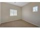 Bedroom showcasing two sunny windows and neutral carpeting, creating a bright and inviting space at 1305 Allegheny Moon Ter # 2, Henderson, NV 89002