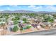 Aerial view of a community neighborhood surrounded by lush greenery and mountain range in the background at 6552 Roy Rogers Dr, Las Vegas, NV 89108