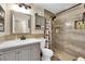 Bathroom featuring a walk-in shower with decorative tile, storage, and neutral colors at 6552 Roy Rogers Dr, Las Vegas, NV 89108