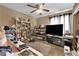 Cozy bedroom with ceiling fan, lots of decorations, and an entertainment center at 6552 Roy Rogers Dr, Las Vegas, NV 89108