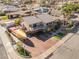Aerial view of a multi-story home features a boat on trailer parked on the driveway surrounded by desert landscape at 868 Marina Dr, Boulder City, NV 89005