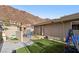 Exterior backyard view includes artificial grass, play house, and the home's exterior, set against the backdrop of a mountain at 868 Marina Dr, Boulder City, NV 89005