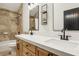 Bathroom with wood cabinets, double sinks, quartz countertop, and walk-in shower at 868 Marina Dr, Boulder City, NV 89005