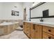 Luxurious bathroom featuring a large soaking tub, dual sinks, and custom wood cabinets at 868 Marina Dr, Boulder City, NV 89005