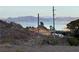 Scenic view of a home near the lake, with mountains visible in the background, under a clear sky at 868 Marina Dr, Boulder City, NV 89005