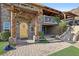 Inviting home featuring a charming stone facade, pergola-covered entrance, and beautiful wooden door at 868 Marina Dr, Boulder City, NV 89005